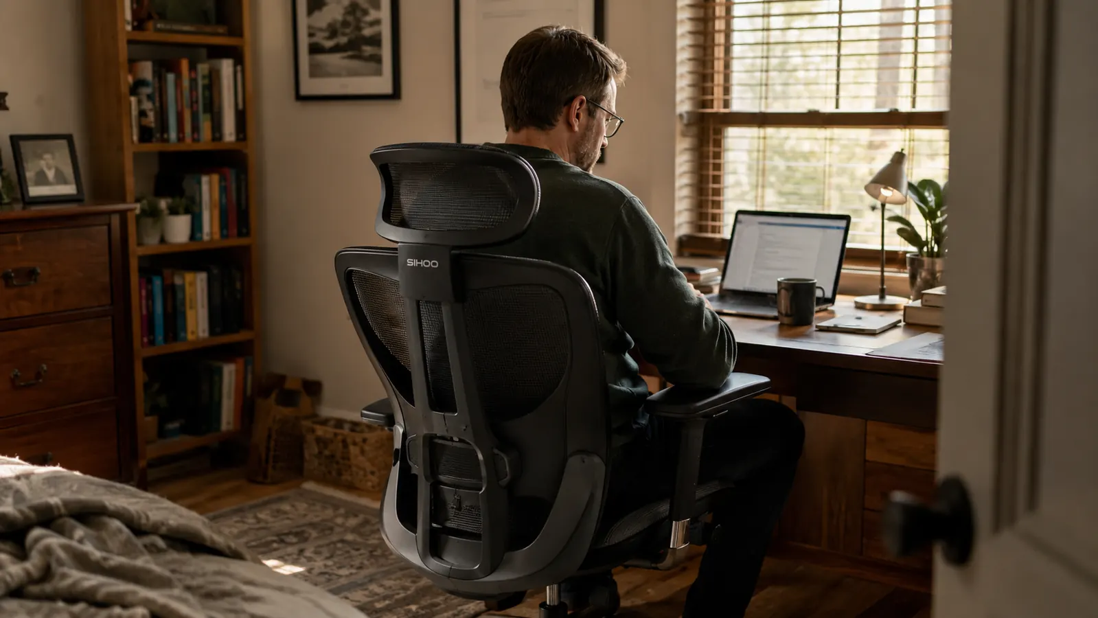 SIHOO B100 mesh office chair sitting at a spare-bedroom desk with morning light coming through a window